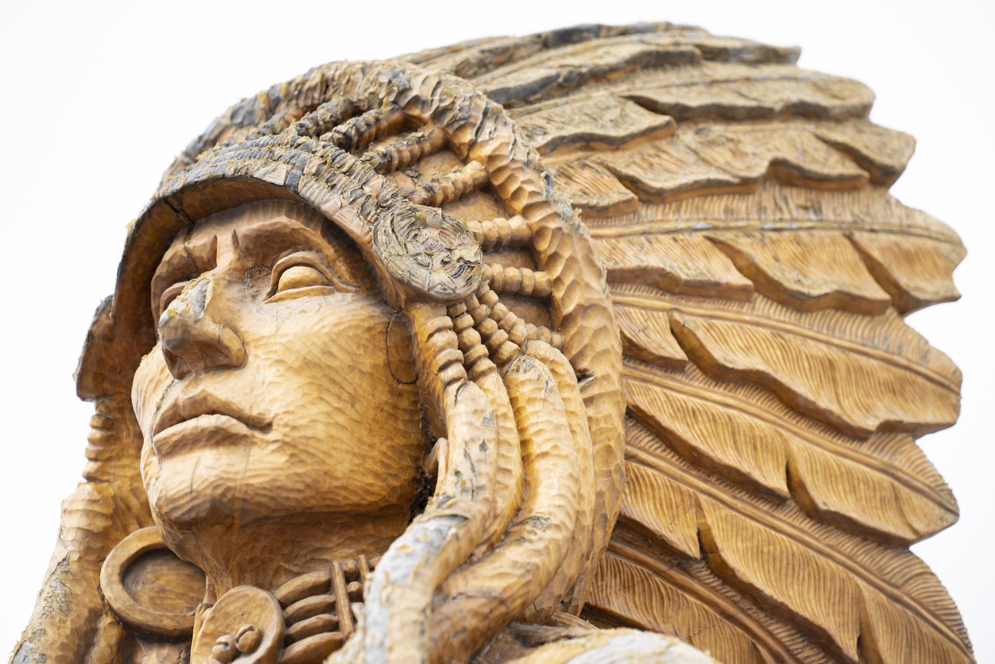 Restored Eddie Running Wolf tree carvings at Lefthand Valley Grange Park, a physical landmark of Indigenous history in the Boulder Valley.